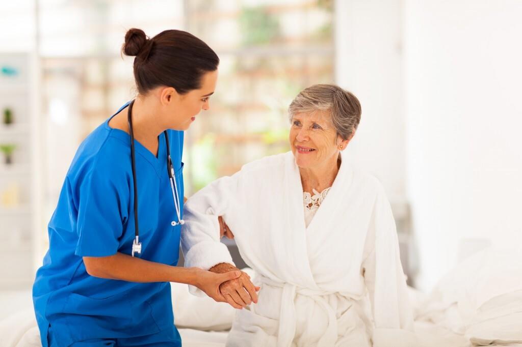 nurse helping an elderly lady