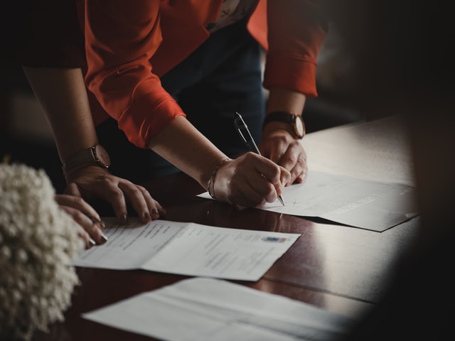 people in an office doing paperwork