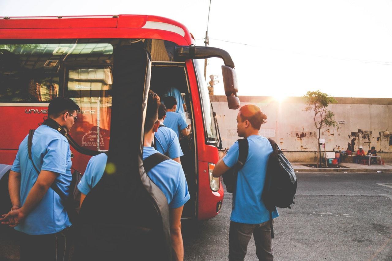 people getting on a bus