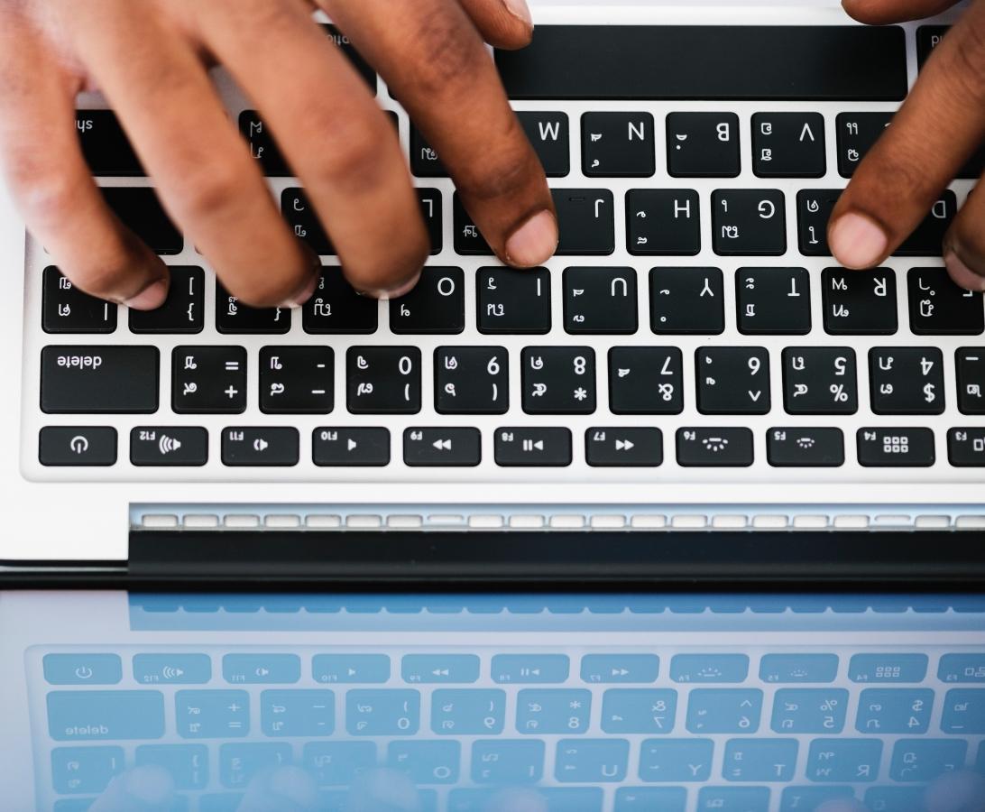 person typing on a laptop