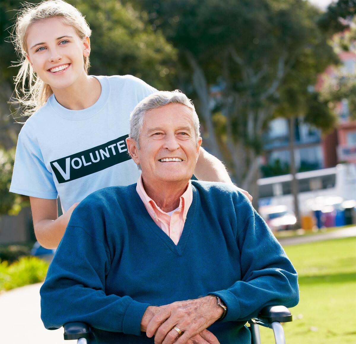 volunteer helping an elderly person